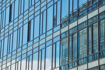 Obraz premium blue glass wall of office building mirror reflection