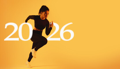 A determined fit lady performs a mid-air run while exercising against a vibrant neon orange studio...