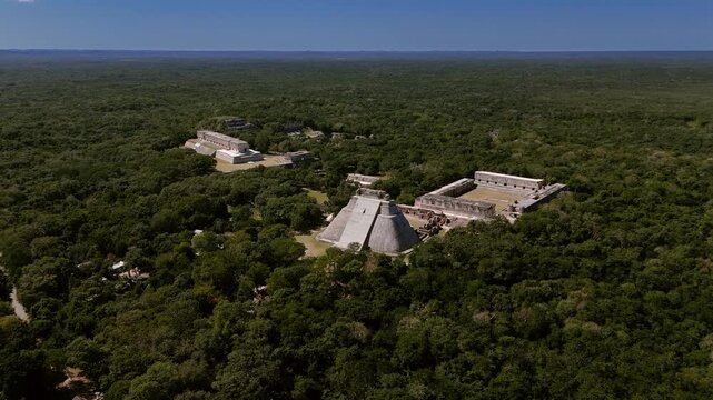 Aerial orbit around Uxmal showing Mayan ruins and forest in Yucatan