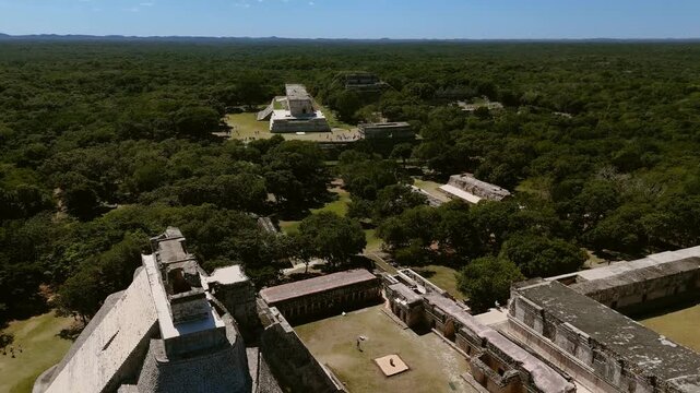 Aerial pull back and pan revealing Pyramid of the Magician in Mayan ruins of Uxmal