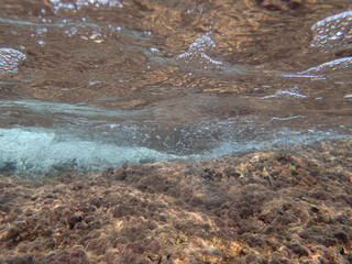 Ocean blue underwater with sunrays, Underwater Sea Deep Water Abstract Sunshine, sea wave , clean waters in summer time, Natural underwater seascape, sand on ocean floor and water surface with sunligh