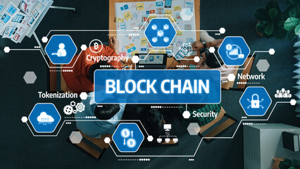 A top-down view of a diverse team brainstorming blockchain concepts surrounded by digital icons...