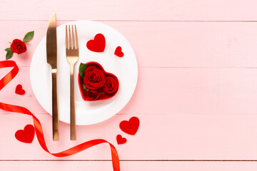 Festive table setting for Valentine's Day on wooden background, top view