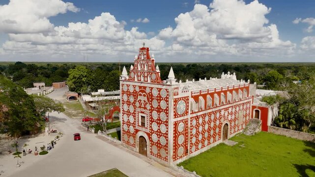 Orbit shot transitioning between side and front views of Templo de Santiago Apostol in Uayma, Yucatan, Mexico, showing colonial architecture and decorative patterns