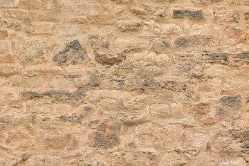 Background of the stone wall fragment of an ancient structure