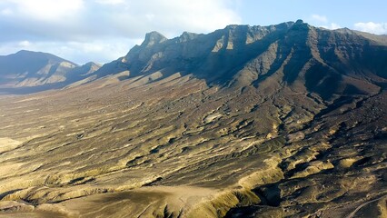 Aerial view of the mountains and hills descending to Sotavento Beach in Cofete, Fuerteventura,...