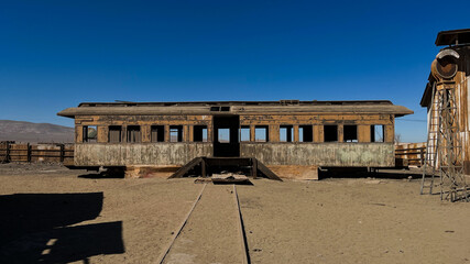 Photo of old discarded railway carriages in Baquedano Railway Museum in Chile.  In the middle of Atacama Desert is the village museum offers an exhibition that retraces the history of the railroad.