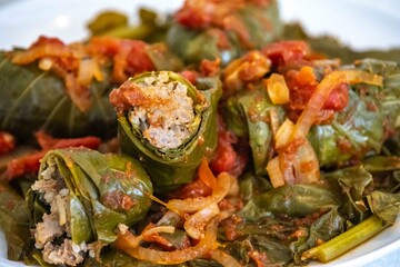 Authentic Ukrainian food known as holupti, cabbage or kale leaves stuffed with rice and ground meat