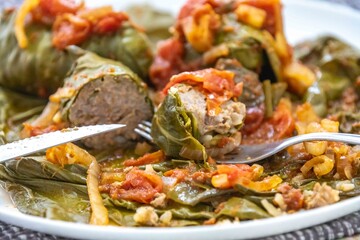 Authentic Ukrainian food known as holupti, cabbage or kale leaves stuffed with rice and ground meat