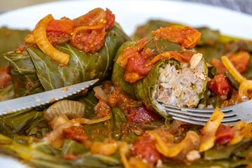 Authentic Ukrainian food known as holupti, cabbage or kale leaves stuffed with rice and ground meat
