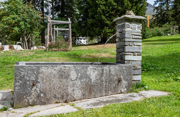 Old water fountain in town of San Bernardino in Swiss