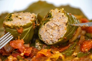 Authentic Ukrainian food known as holupti, cabbage or kale leaves stuffed with rice and ground meat