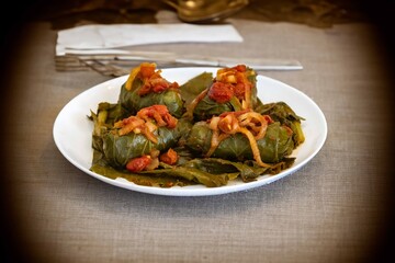 Authentic Ukrainian food known as holupti, cabbage or kale leaves stuffed with rice and ground meat