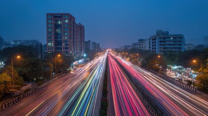 Obraz premium Vibrant Night Cityscape with Light Trails from Traffic on Busy Urban Highway at Dusk
