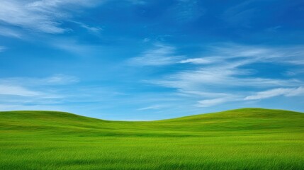 Fototapeta premium Expansive Green Hills Under a Bright Blue Sky with Wispy Clouds and Natural Serenity