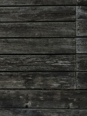 A closeup of old weathered wooden planks with faded texture and natural grain