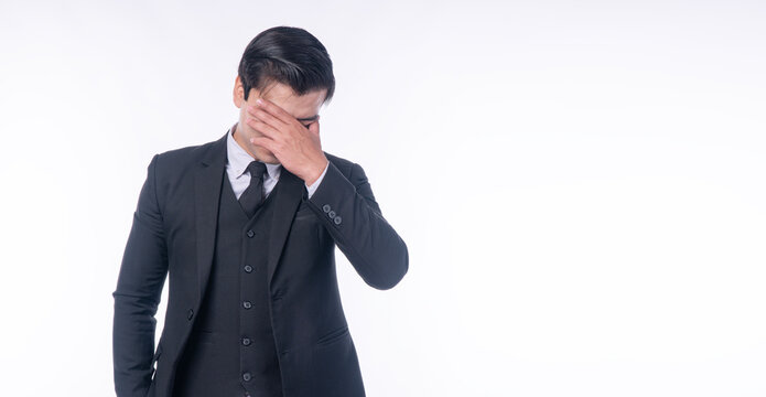 Disappointment unhappy businessman holding hands on nose worry problem over isolated white background. Serious tired handsome man suit distressed holding hands on facd sadness. Upset loss guy despair.