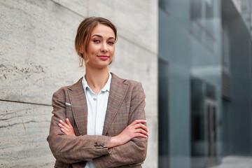 Businesswoman successful woman business person standing arms crossed outdoor corporate building exterior Smile happy caucasian confidence professional business woman middle age female entrepreneur
