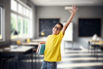 Happy child boy in class with book and glasses