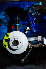 New brake rotor and caliper installation on custom suspension. High-performance brake and coilover...