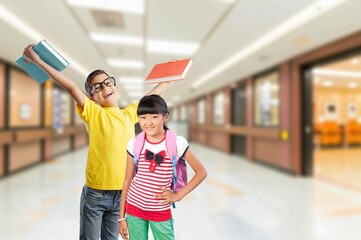 Happy child boy in class with book and glasses