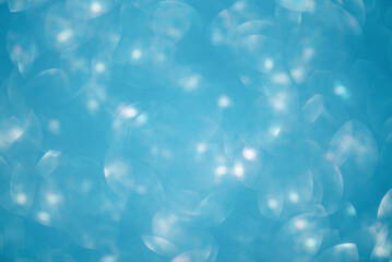 Defocus light glitter blue. Abstract blurred background of blue sparkles.