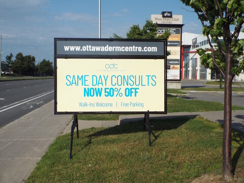 Ottawa, ON, Canada, June 18, 2025: A light yellow color and advertises "SAME DAY CONSULTS" for "odc OTTAWA DERM and SURGERY CENTRE," on Alta Vista Dr.
