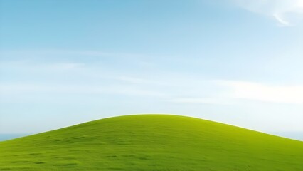 A single grassy hill under a wide empty sky, presented in a clean rule of thirds composition with soft natural light