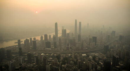 Fototapeta premium Smoggy Skyline of a Modern City at Sunrise, with a River and Tall Buildings