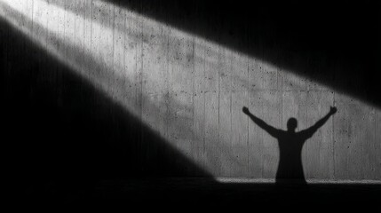 Shadow silhouette with raised arms under sharp monochrome light symbolizing struggle and defiance