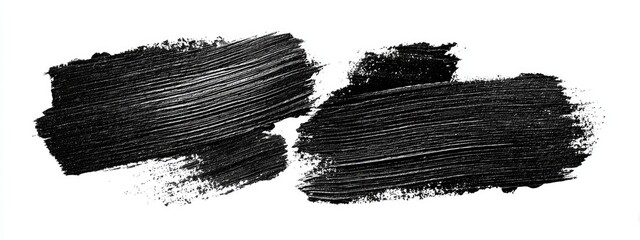Two dark, textured brushstrokes on a white background