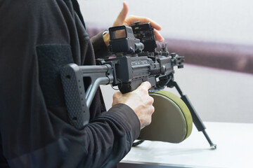 A man with a machine gun in the weapon store