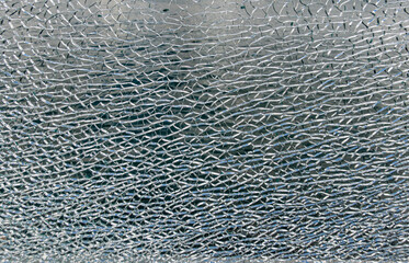 Shattered safety glass creating abstract texture pattern