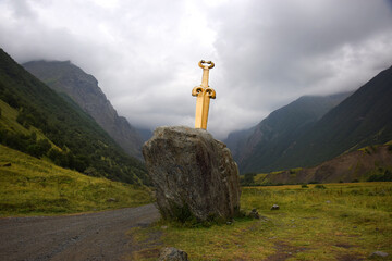 A Scythian sword in stone in the Midagrabinsky Falls Valley in the mountains of North Ossetia, Russia. Autumn in the Caucasus Mountains.