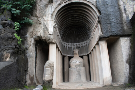 entrance of aurangabad cave 4, ancient buddhist rock cut architecture with intricate details, part of the historic cave complex