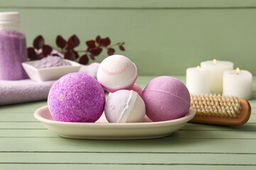 Composition with tray and bath bombs on green wooden background, closeup