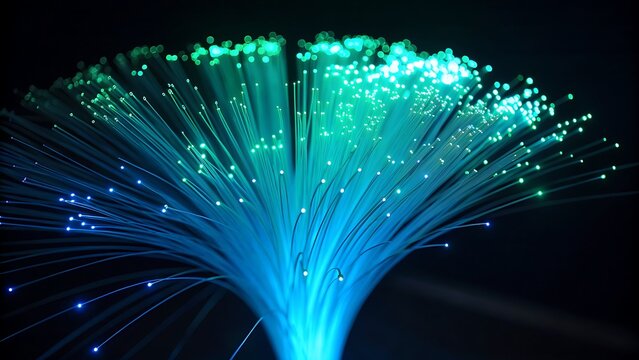 Fiber optics glowing in blue and green on black. Suitable for technology, networking, data transfer, internet concepts in designs.