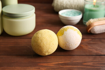 Composition with bath bombs on brown wooden background, closeup