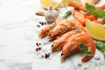 Delicious seafood dish. Tasty grilled shrimps and products on white marble table, closeup. Space for text