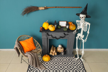 Interior of living room decorated for Halloween with fireplace, armchair and human skeleton