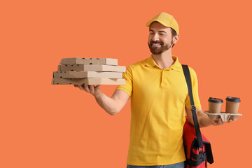 Male courier with pizza boxes and coffee cups on orange background