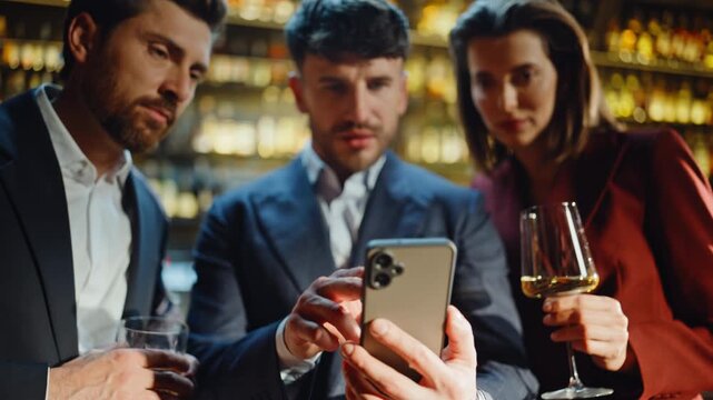 Hands scrolling smartphone night bar closeup. Joyful team reacting great news