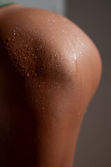 Fototapeta premium Macro close up of athletic female body with wet skin and sweat drops, highlighting natural texture, sensual detail and fitness lifestyle concept