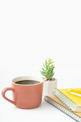 Find focus with a hot cup of coffee and a vibrant succulent next to your notebook for a productive day, ideal for creative projects and study sessions
