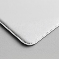 Close up shot of a white textured surface with stitched edge on a gray background in soft lighting
