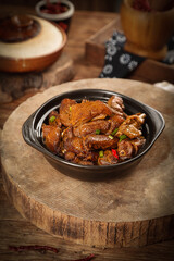 Wood-fired goose stew in ceramic pot on rustic wooden board - traditional farmhouse cooking © NguyenThi