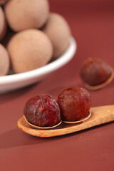 Obraz premium Yunnan Style Dried Fruit Dumplings Traditional Chinese Cuisine Wooden Spoon Presentation