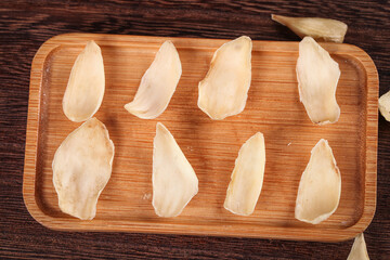 Dried Chinese Lily Bulb Petals Traditional Herbal Medicine Ingredients on Wooden Tray Closeup