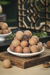 Fresh Longan Tropical Fruit from Guangdong Yunnan China on Wooden Table