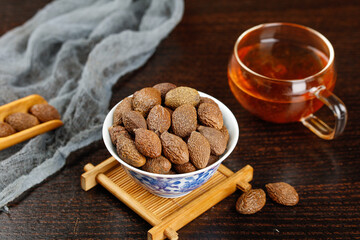 Dried Fruits in Bowl with Herbal Tea on Wooden Table - Healthy Natural Snack and Wellness Concept